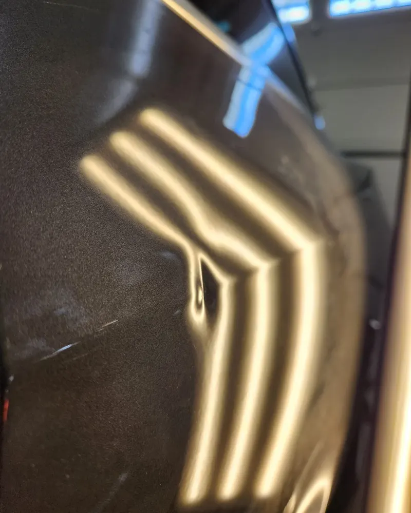Before: quarter panel dent